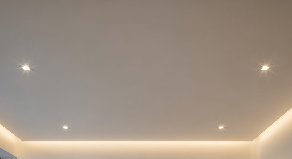 Simple Ceiling Decor Design That Transforms Any Room 3 A modern ceiling with recessed LED lights, smooth surface, and soft warm glow, creating a sleek and minimalist living room look.