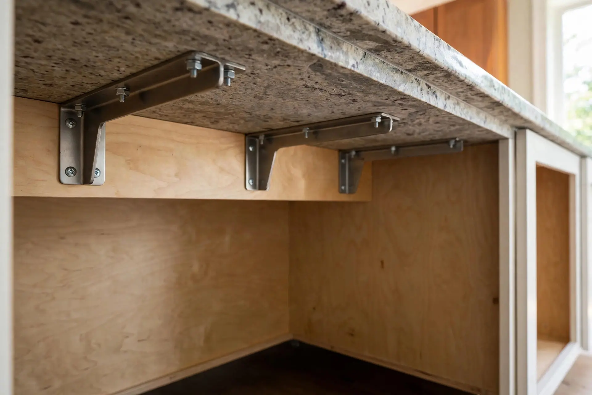 Kitchen Island Seating Ideas: The Measurements That Make It Comfortable 4 Hidden steel brackets supporting a kitchen island countertop overhang with clear knee space